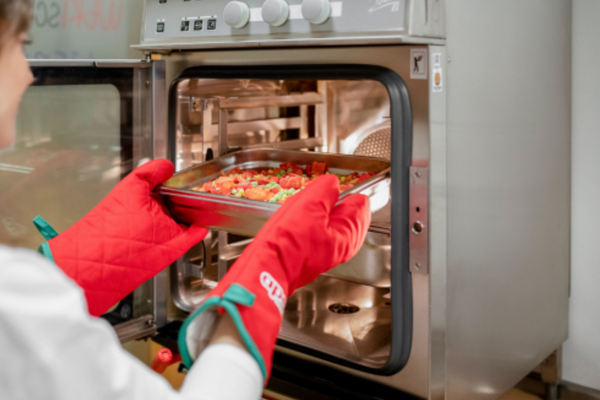 Essen wird in das Zubereitungsgerät geschoben